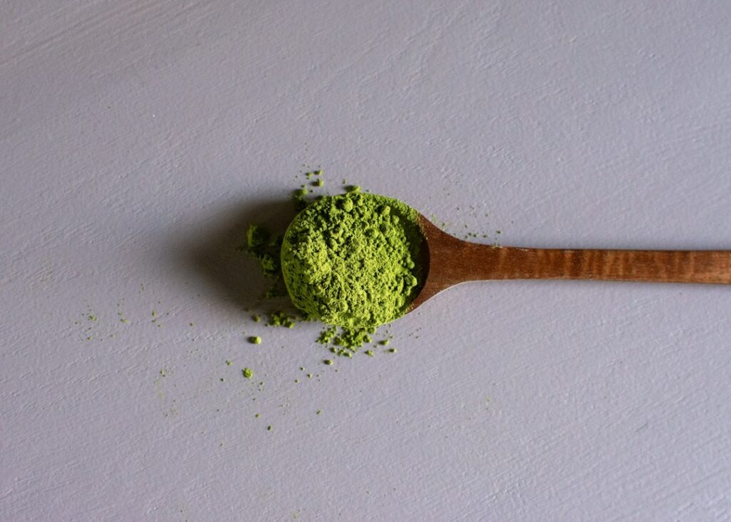 Polvo de matcha verde sobre una cuchara de madera